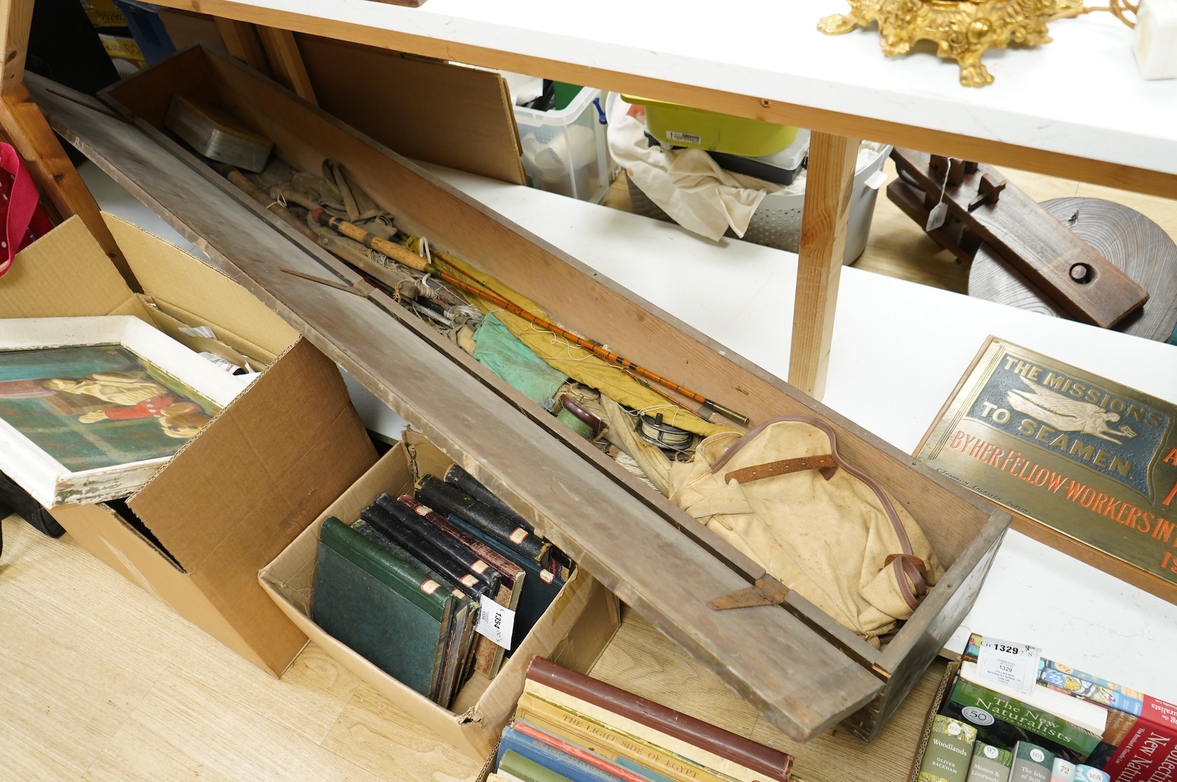 A collection of split cane fishing rods, reels, landing net etc contained in a large wooden box